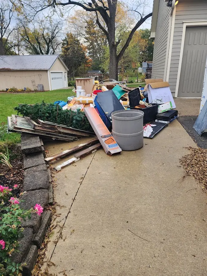 Dumpster being loaded with debris for Estate Cleanout Dumpster Rental in Elon